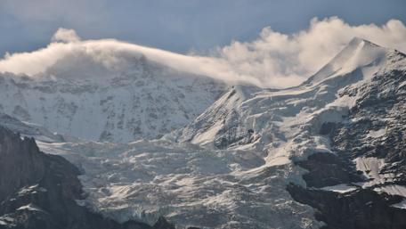 High mountains with snow and clouds wallpaper