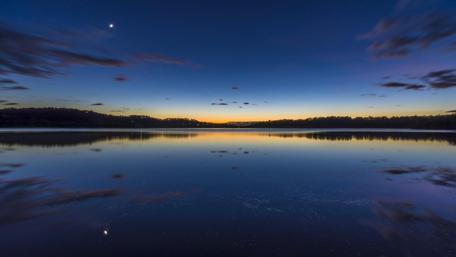 Night sky reflected in loch wallpaper