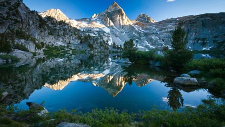 Mountains reflected in the crystal clear water wallpaper
