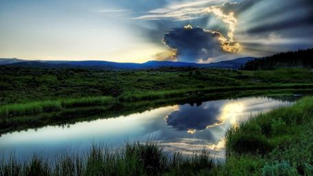 Morning sunrays shining behind the cloud wallpaper
