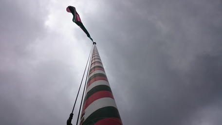Bold Flag Above Stormy Skies wallpaper