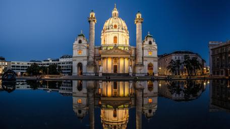 Enchanting Vienna Nightscape Featuring Karlskirche Reflections wallpaper