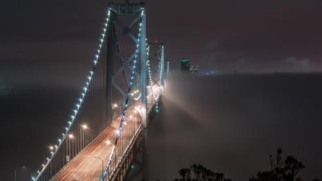 The misty San Francisco–Oakland Bay Bridge at night wallpaper