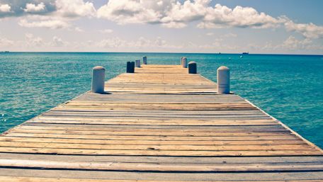 Sunny endless ocean dock view wallpaper