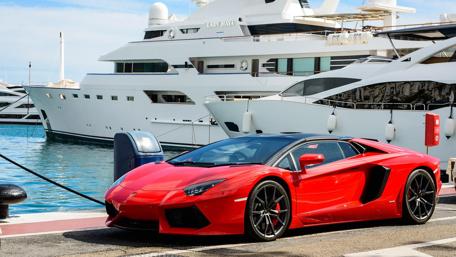 Red Lamborghini Against Large White Yatch wallpaper