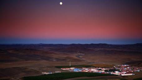 Serene Cityscape Under a Moonlit Sky wallpaper