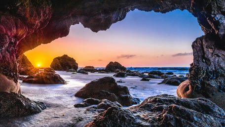 Epic sunset from a sea cave wallpaper