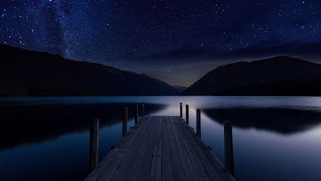 Long pier above a lake at night wallpaper