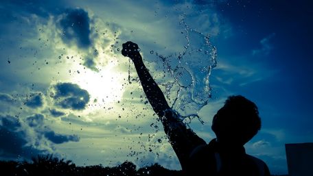 Joyful Splash Under a Blue Sky wallpaper