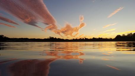 Serene Sunset Reflection Over Calm Waters wallpaper