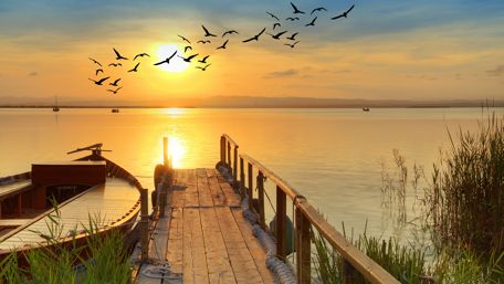 Pier with a boat at dawn wallpaper