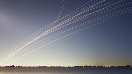 Contrails on the night sky wallpaper