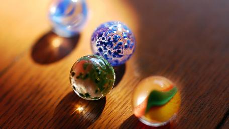 Vibrant Marbles on a Wooden Surface wallpaper