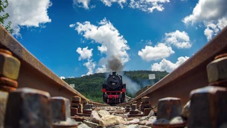 Classic Steam Locomotive Against a Scenic Backdrop wallpaper