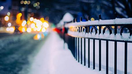 Snowy street with bokeh lights wallpaper