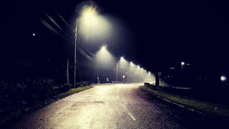 Mysterious Night Road Beneath Streetlights wallpaper