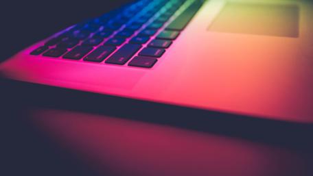 Laptop in colorful lights wallpaper