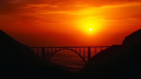 Vibrant Sunset Over Majestic Bridge wallpaper