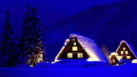 Cozy Winter Cabin Under a Starry Night Sky wallpaper