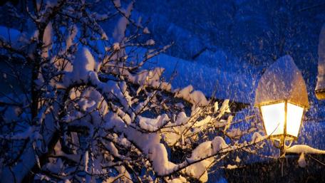Winter Lantern Glows Brightly Amidst Snowfall wallpaper