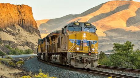Powerful Freight Train in Scenic Landscape wallpaper