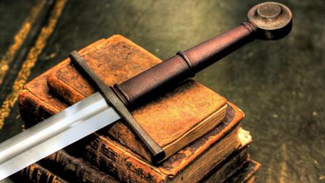 Sword of Wisdom Resting on Ancient Tomes wallpaper