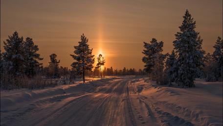 Sunset shining on the winter road wallpaper