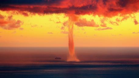 Majestic Tornado Over Sunset Sea Scene wallpaper