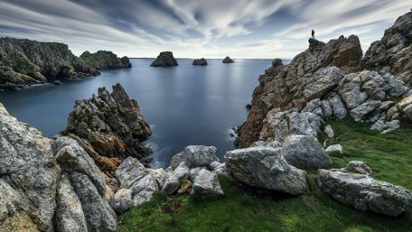 Majestic Coastal Fjord Under a Cloudy Sky wallpaper