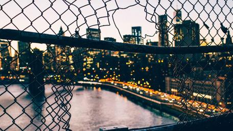 Urban Perspectives Through a Fence Hole wallpaper