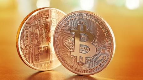 Golden Bitcoins on Warm Toned Background wallpaper