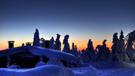 Snowcapped log cabin wallpaper
