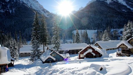 Winter Wonderland Village Under Sunny Mountains wallpaper