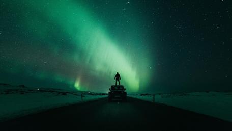 Man under the polar lights wallpaper