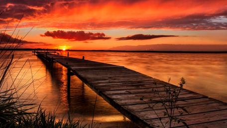 Serene Sunset Over Tranquil Lake Pier wallpaper