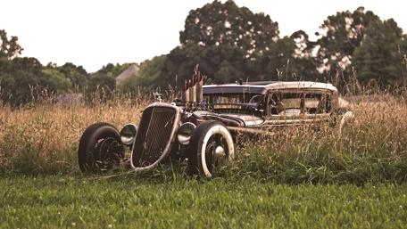 Vintage Car Lost in a Serene Pasture Setting wallpaper