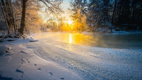 Serene Winter Sunrise Over Frozen Landscape wallpaper