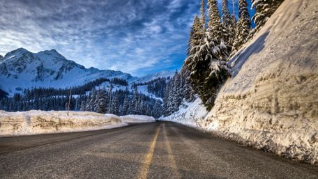 Winter Road Through Majestic Mountains with Snowy Landscape wallpaper