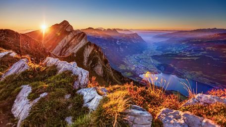 Breathtaking Mountain Sunrise Over Tranquil Valley wallpaper