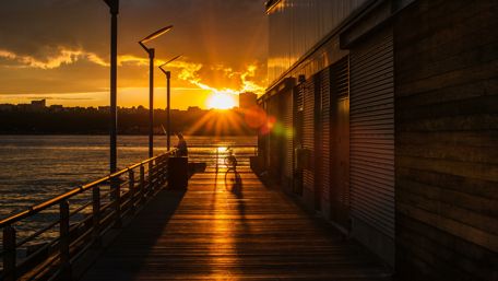 Golden Sunset Over Pier and Water Scene wallpaper