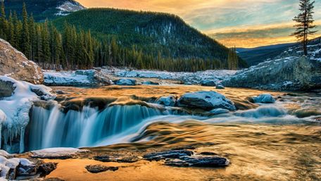 Serene Winter Waterfall in Majestic Wilderness Landscapes wallpaper