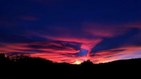 Vibrant Silhouette Against a Stunning Sunset Sky wallpaper