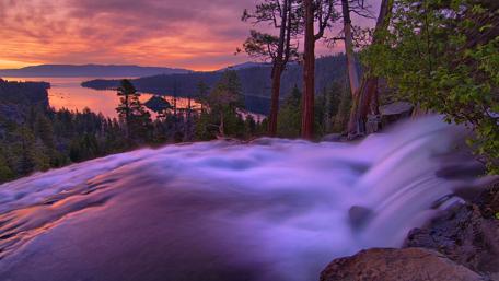 Majestic Sunset Over Serene Waterfall Landscape wallpaper