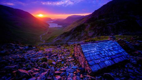 Majestic Highland Sunset Over a Serene Valley wallpaper