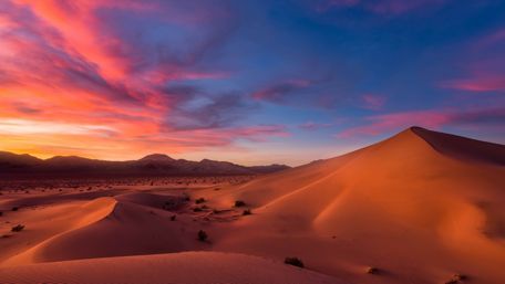 Stunning Desert Sunset Over Dunes wallpaper