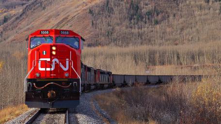 Train Cutting Through Serene Highlands wallpaper