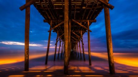 Beneath the Tranquil Pier at Sunrise wallpaper