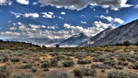 Majestic Highland Landscape Under a Cloudy Sky wallpaper