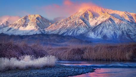 Majestic Winter Dawn Over Snow-Capped Mountains wallpaper