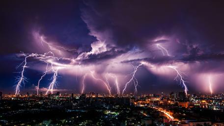 Thunderous Majesty Over Cityscape wallpaper
